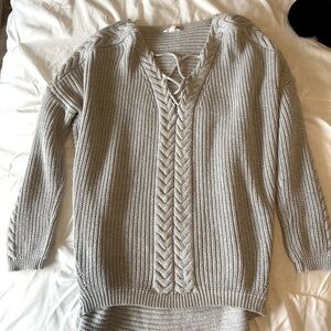 Gray sweater with braided design in the front
